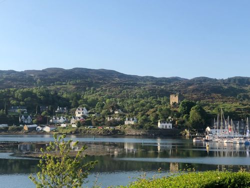 Tarbert Castle overlooking the bustling coastal village.